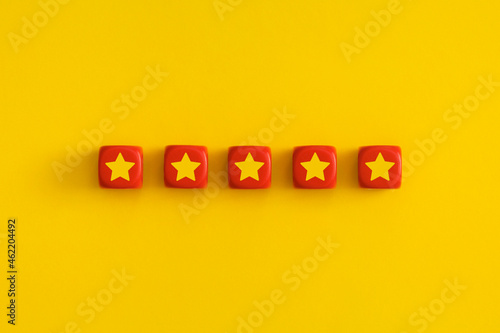 Golden five 5 stars  best excellent services rating on a red cubes