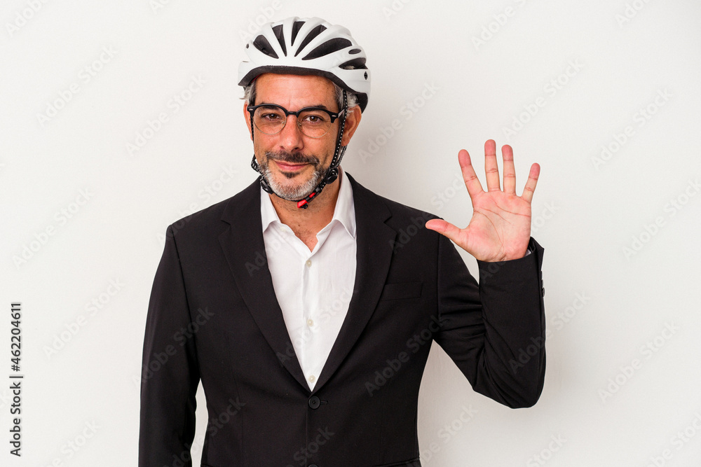 Middle age business man wearing a bike helmet isolated on blue background smiling cheerful showing number five with fingers. Middle age business man wearing a bike helmet isolated on blue background smiling cheerful showing number five with fingers.