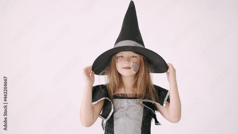 Portrait of little girl in black hat and black clothing on white background