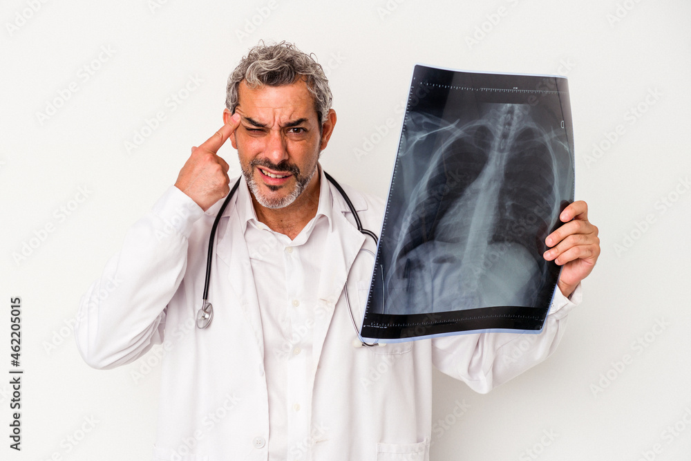 Middle age doctor caucasian man holding a radiography isolated on white background showing a disappointment gesture with forefinger. Middle age doctor caucasian man holding a radiography isolated on white background showing a disappointment gesture with forefinger.