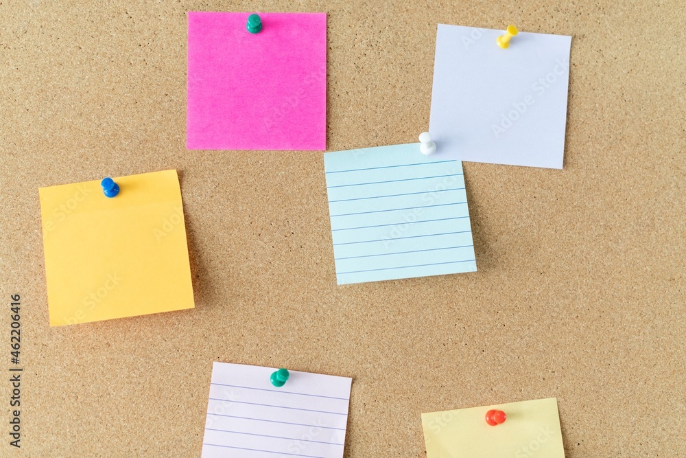 Pinned notes, blank memo on brown corkboard Pinned notes, blank memo on brown corkboard