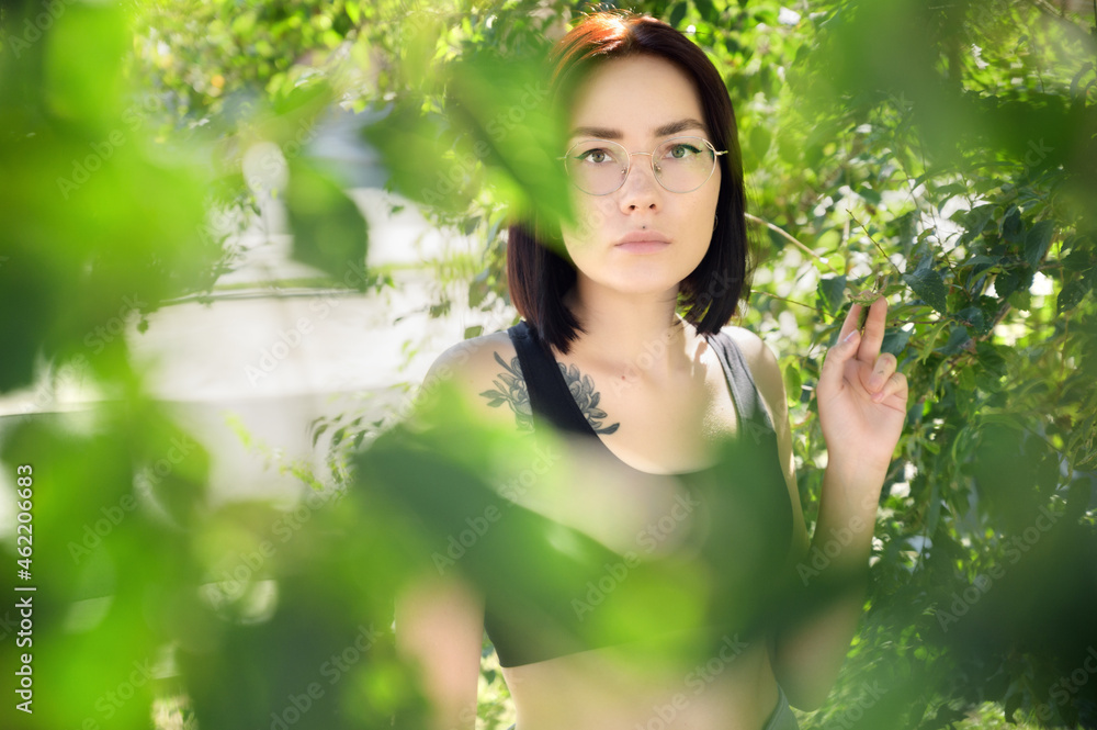 Portrait of beautiful young woman in city park. Portrait of beautiful young woman in city park.