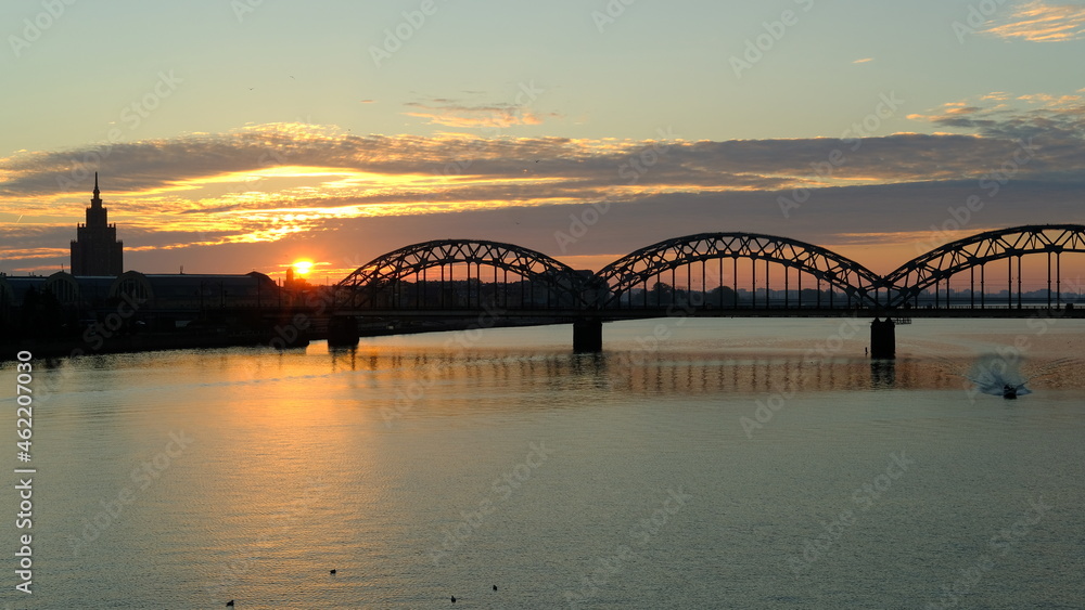 Railway bridge in Riga against the background of dawn in autumn. Railway bridge in Riga against the background of dawn in autumn.