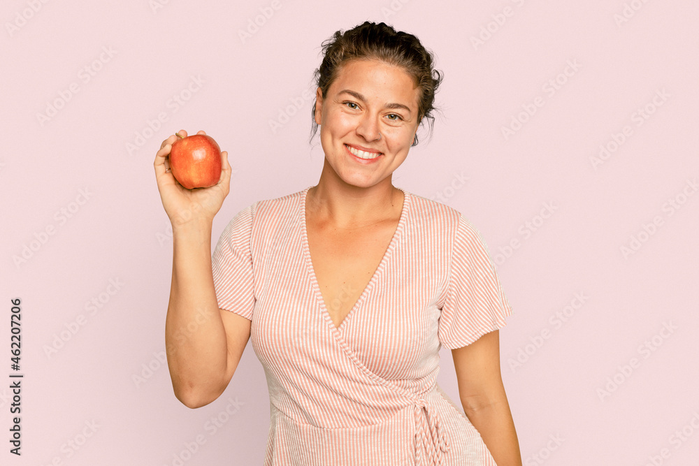 Woman holding apple for healthy eating campaign Woman holding apple for healthy eating campaign