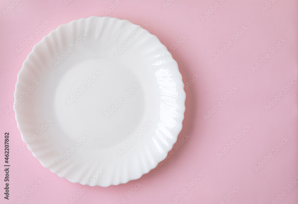 White dinner plate with soft shadow on a light pink surface background. Ready to drop your food White dinner plate with soft shadow on a light pink surface background. Ready to drop your food