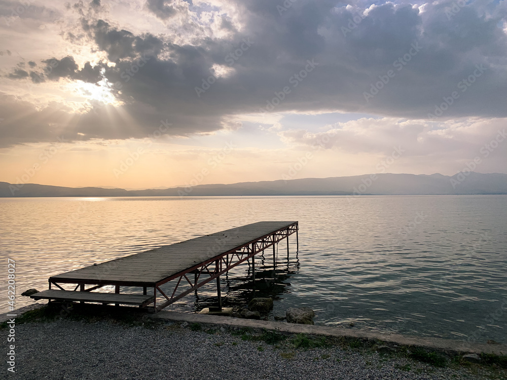 Obraz premium Small wooden pier at the sea, sunset time, no people