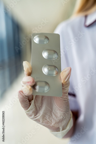 nurse s hands holding packs of pills in hands