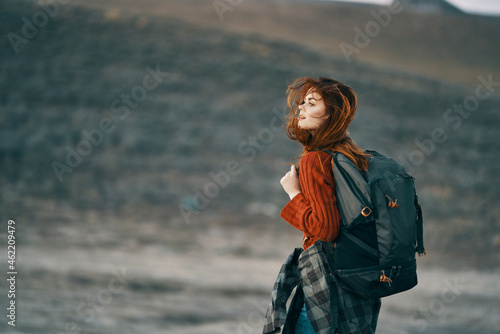 woman hiker in mountains travel with backpack landscape