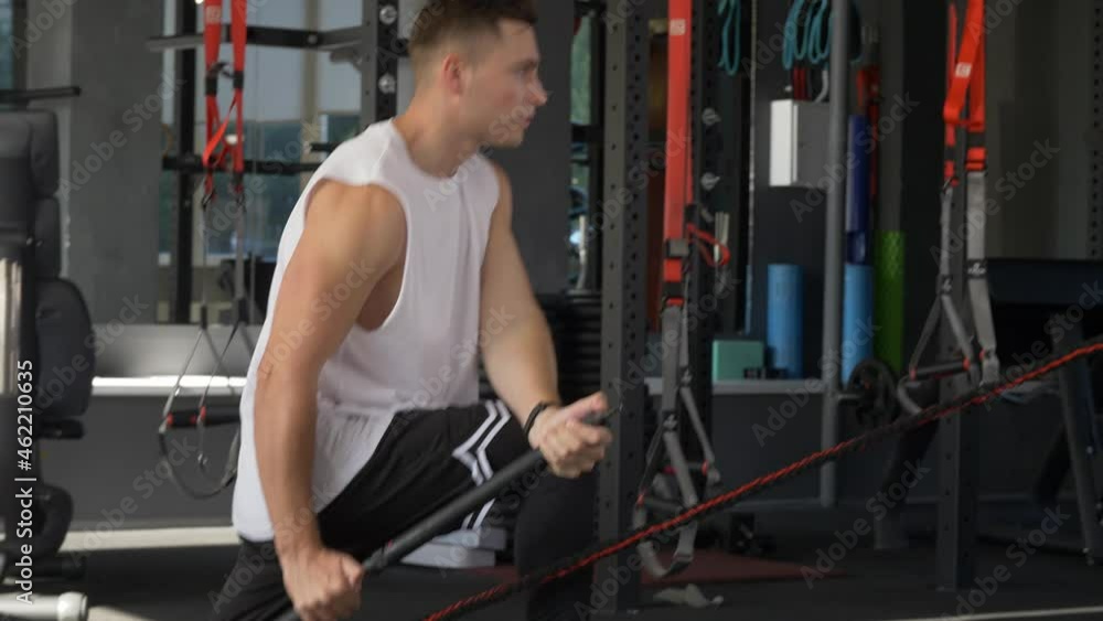 athletic male training at a fitness club with a body bar, young man working out with crossbar at the gym, healthy active lifestyle athletic male training at a fitness club with a body bar, young man working out with crossbar at the gym, healthy active lifestyle