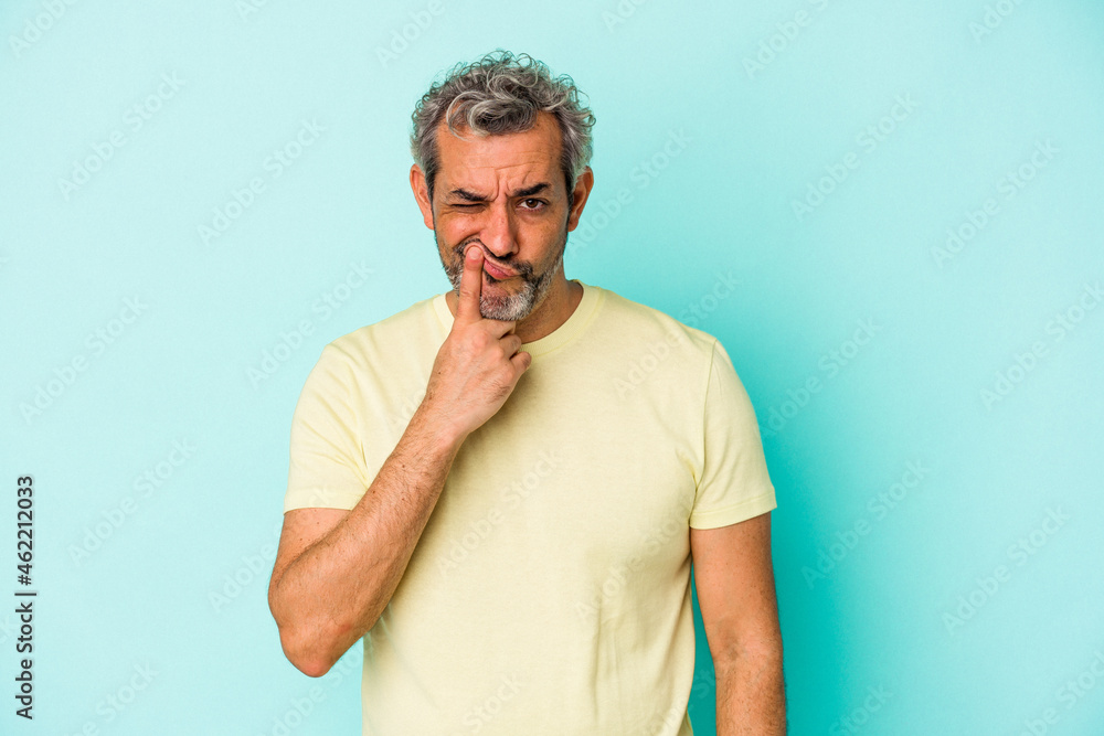 Middle age caucasian man isolated on blue background thinking and looking up, being reflective, contemplating, having a fantasy. Middle age caucasian man isolated on blue background thinking and looking up, being reflective, contemplating, having a fantasy.