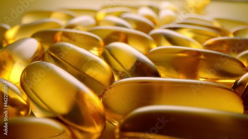 Macro shot of medications pills and tablets. Fish Oil Omega 3 transparent capsules close-up. photo