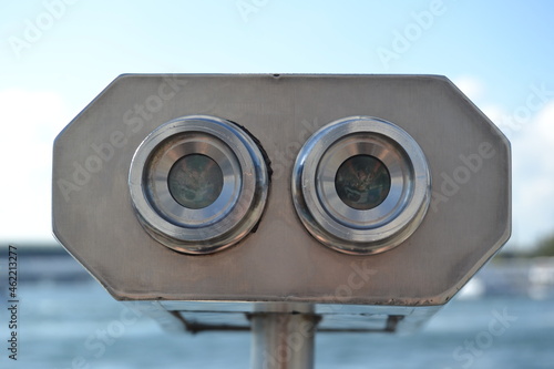 Close up of lenses of coin operated binoculars.