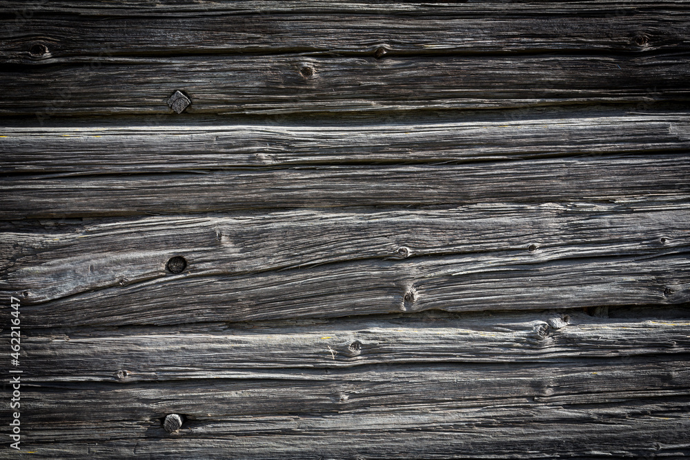 Wooden logs of an old house. Close-up. Weathered natural gray wood texture. Background. Horizontal photo Wooden logs of an old house. Close-up. Weathered natural gray wood texture. Background. Horizontal photo