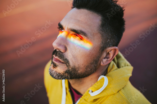 Mature man with spectrum on eyes while looking away photo