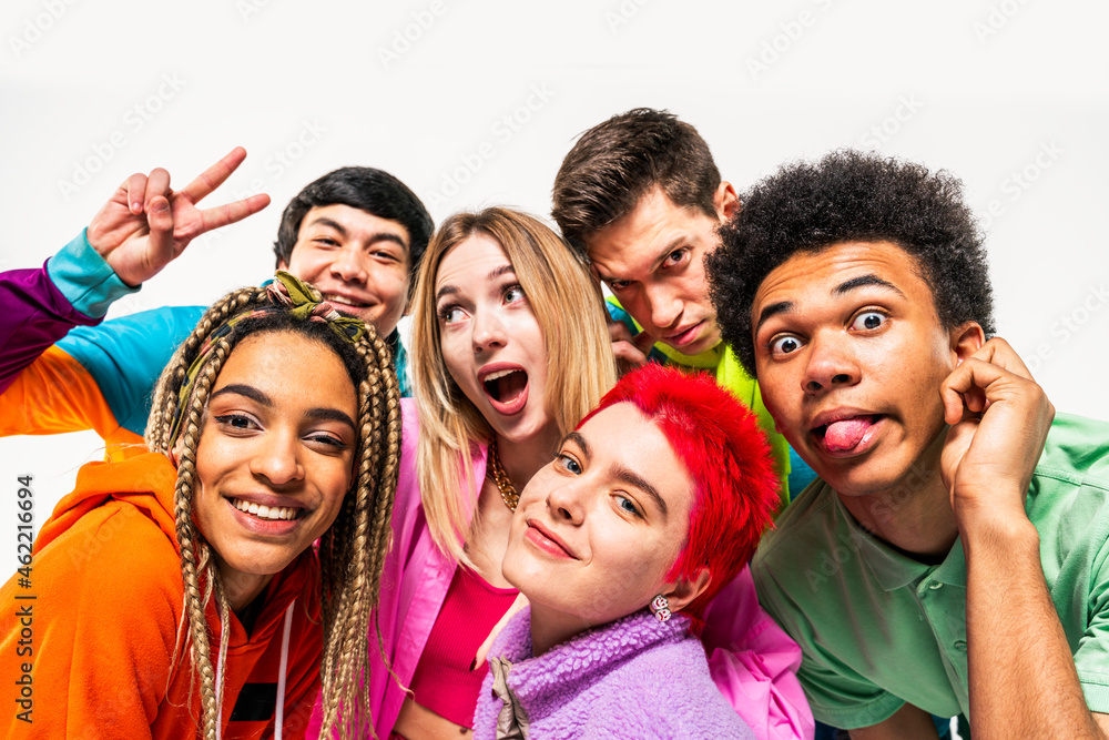 Young friends enjoying while making faces on white background Young friends enjoying while making faces on white background