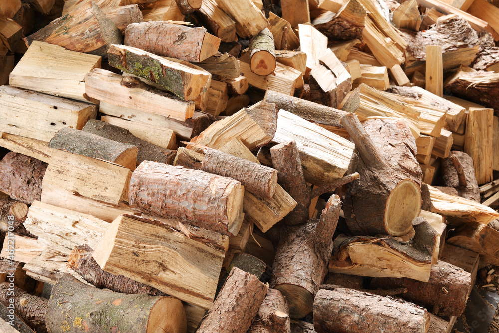 Closeup of chopped firewood. Firewood stacked and prepared for winter. Pile of wood. Closeup of chopped firewood. Firewood stacked and prepared for winter. Pile of wood.