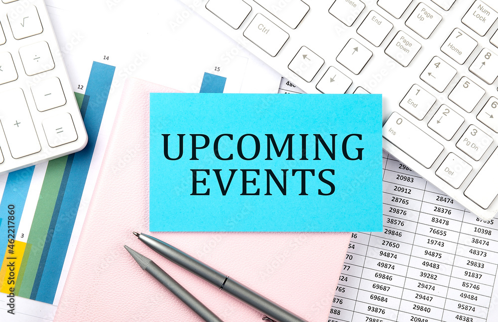 UPCOMING EVENTS text on blue sticker on chart with calculator and keyboard,Business concept UPCOMING EVENTS text on blue sticker on chart with calculator and keyboard,Business concept