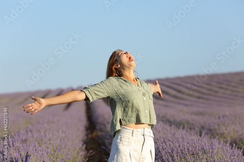 Fototapeta Naklejka Na Ścianę i Meble -  Woman screaming and spreading in a lavender field