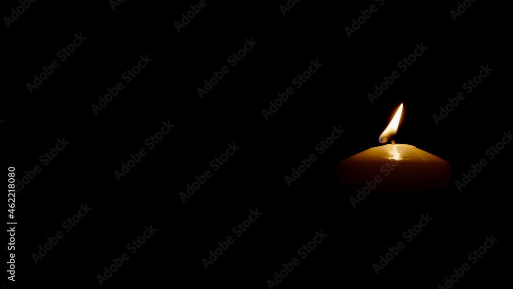 Close up Burning candle isolated on black background right side of picture Close up Burning candle isolated on black background right side of picture