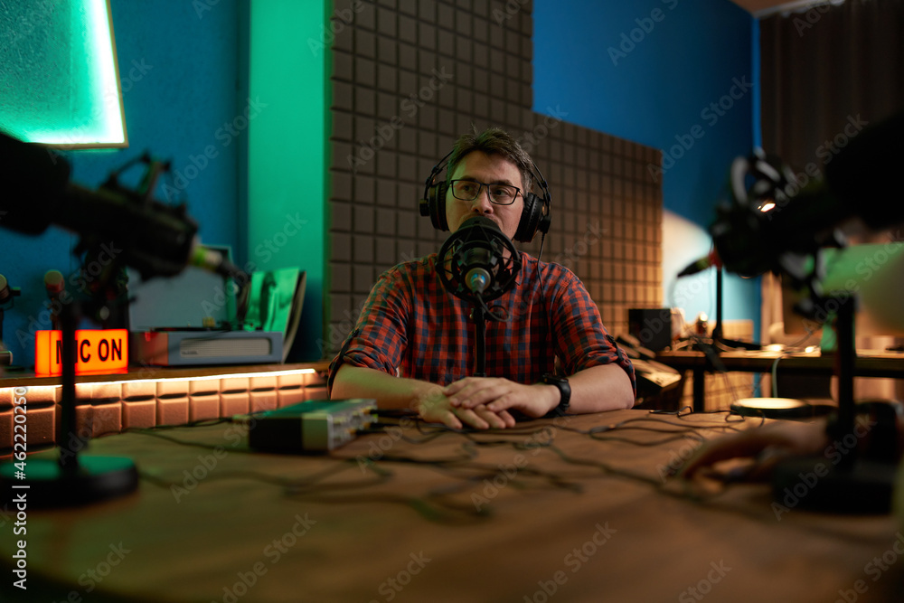 Male podcaster recording audio in studio Male podcaster recording audio in studio