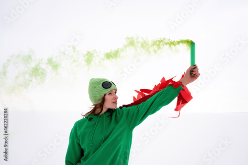 Woman holding distress flare in air against sky photo