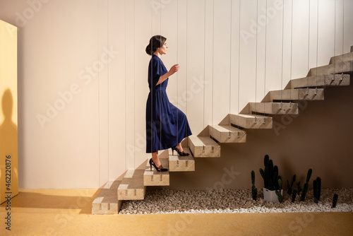 Young woman moving up on staircase photo