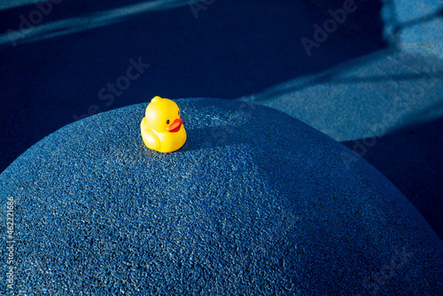 Yellow rubber duck on blue structure at skateboard park photo