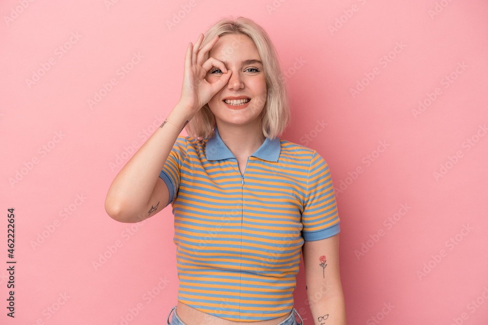 Young caucasian woman isolated on pink background excited keeping ok gesture on eye. Young caucasian woman isolated on pink background excited keeping ok gesture on eye.