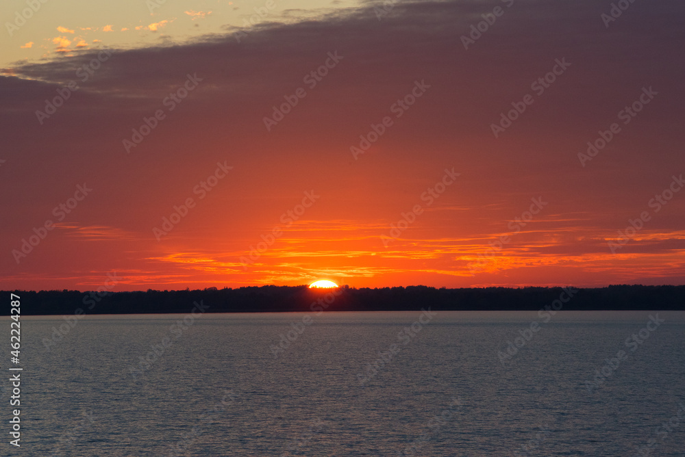 Beautiful lake sunset with red sky and small waves Beautiful lake sunset with red sky and small waves