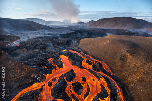 Volcanic eruption. Fresh hot lava, flames and poisonous gases going out from the crater.