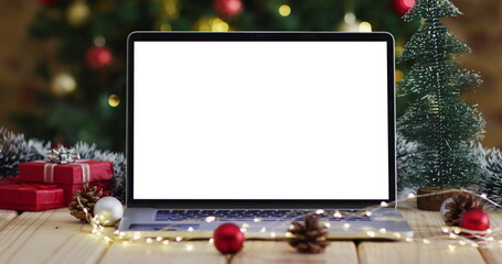 Laptop with copy space on screen, with christmas decorations and tree
