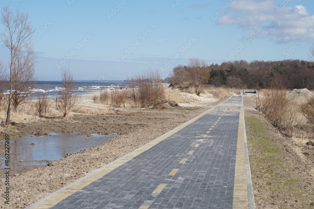 Construction of a bicycle lane. Bicycle lane along the sea. Unfinished pedestrian road. New bicycle lane made of sidewalk tiles.