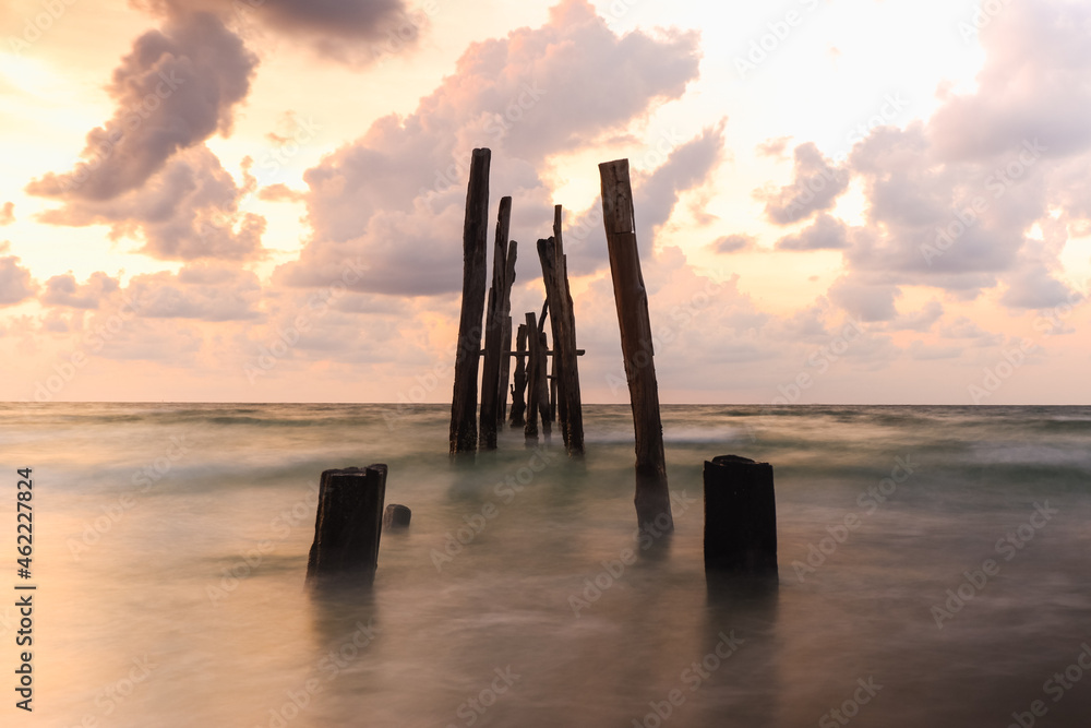 Old wooden bridge abandoned pier stumps at Thungsang bay in Chomphon province Thailand, Tropical beach seaside, White Balance effect