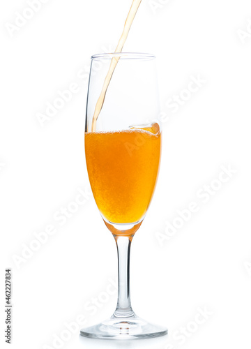pour orange soda into Champagne  glass isolated on white background