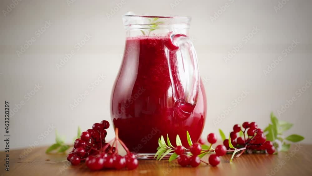 freshly squeezed thick natural juice with pulp from ripe red viburnum in a decanter freshly squeezed thick natural juice with pulp from ripe red viburnum in a decanter