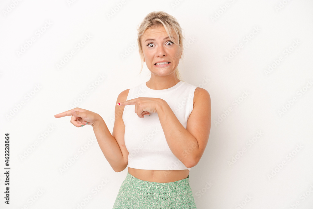 Young Russian woman isolated on white background shocked pointing with index fingers to a copy space. Young Russian woman isolated on white background shocked pointing with index fingers to a copy space.