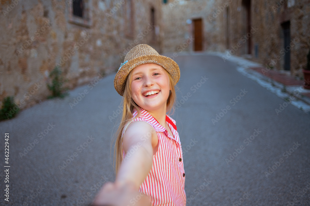 smiling modern girl sightseeing with mother in Tuscany, Italy
