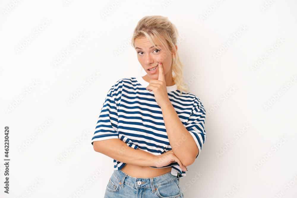 Young Russian woman isolated on white background looking sideways with doubtful and skeptical expression. Young Russian woman isolated on white background looking sideways with doubtful and skeptical expression.