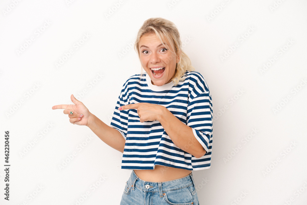 Young Russian woman isolated on white background excited pointing with forefingers away. Young Russian woman isolated on white background excited pointing with forefingers away.