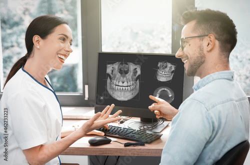 Dentist and patient consultation with x-ray image photo