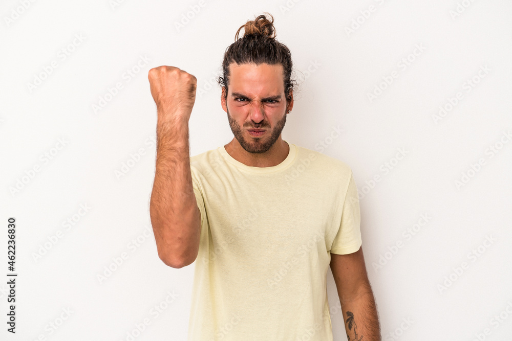 Young caucasian man isolated on white background showing fist to camera, aggressive facial expression. Young caucasian man isolated on white background showing fist to camera, aggressive facial expression.