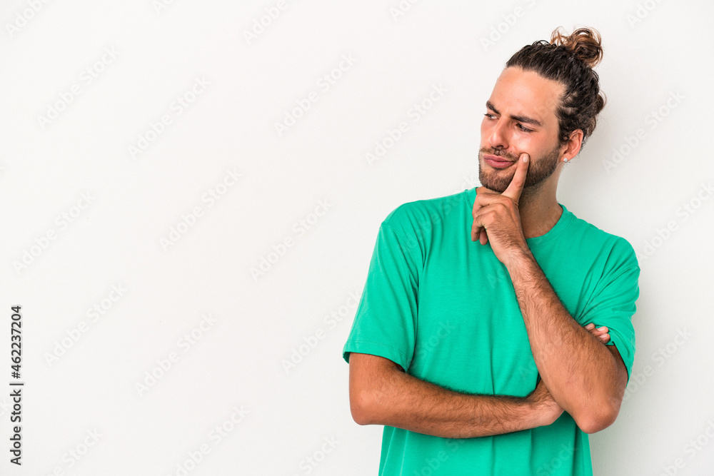 Young caucasian man isolated on white background looking sideways with doubtful and skeptical expression. Young caucasian man isolated on white background looking sideways with doubtful and skeptical expression.