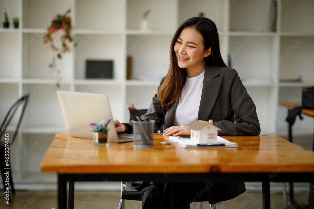 Asian business woman real estate agent home loan working at the office. signs a purchase contract or mortgage for a home, Real estate concept. Asian business woman real estate agent home loan working at the office. signs a purchase contract or mortgage for a home, Real estate concept.