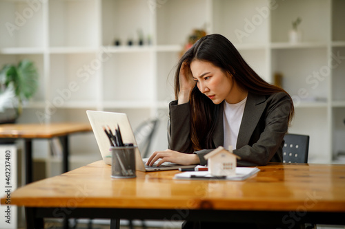 Asian business woman real estate agent home loan working at the office. signs a purchase contract or mortgage for a home, Real estate concept.