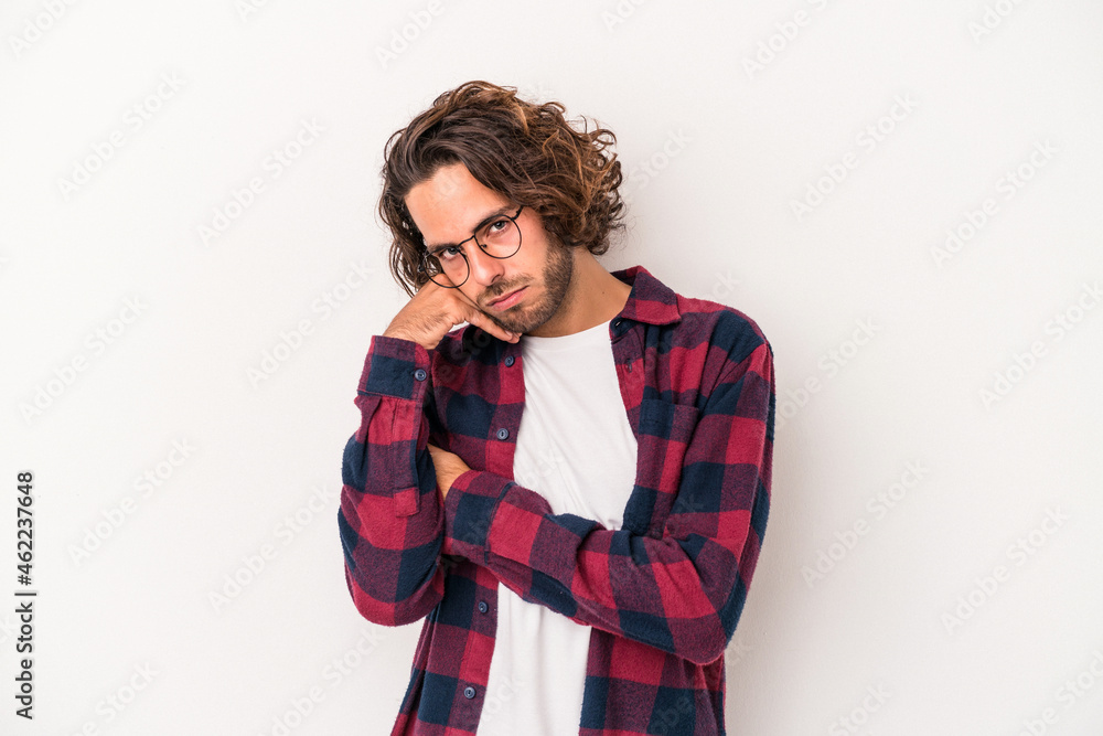 Young caucasian man isolated on white background tired of a repetitive task. Young caucasian man isolated on white background tired of a repetitive task.