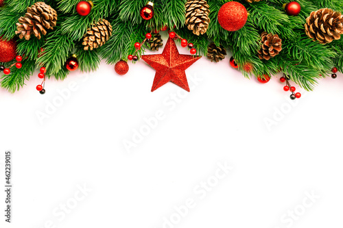 Christmas and New Year background with green spruce branches  cones  balls  star and red berries  white banner  top view  copy space