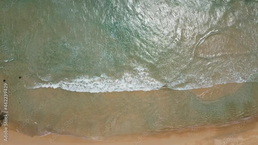 Aerial view of white sand beach and ocean wave. Zoom out. Aerial view of white sand beach and ocean wave. Zoom out.