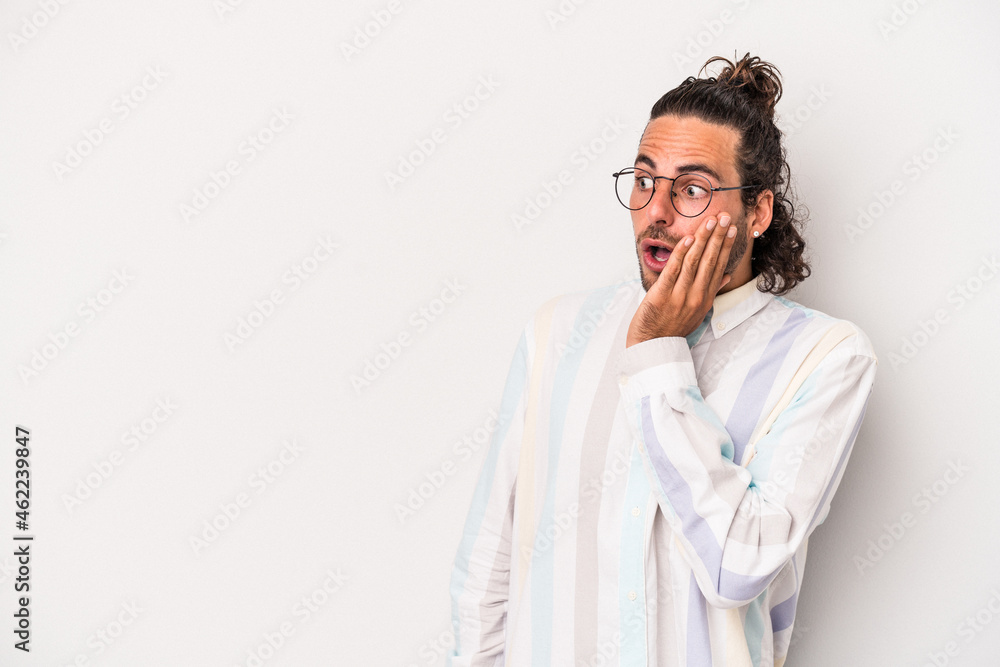 Young caucasian man isolated on gray background being shocked because of something she has seen. Young caucasian man isolated on gray background being shocked because of something she has seen.