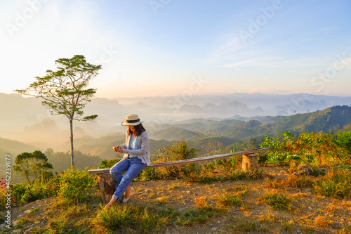 Wallpaper Mural young asia woman feeling happy wearing hat resting on tropical mountain at Doi Ta Pang (khao thalu) travel in chumphon thailand Torontodigital.ca