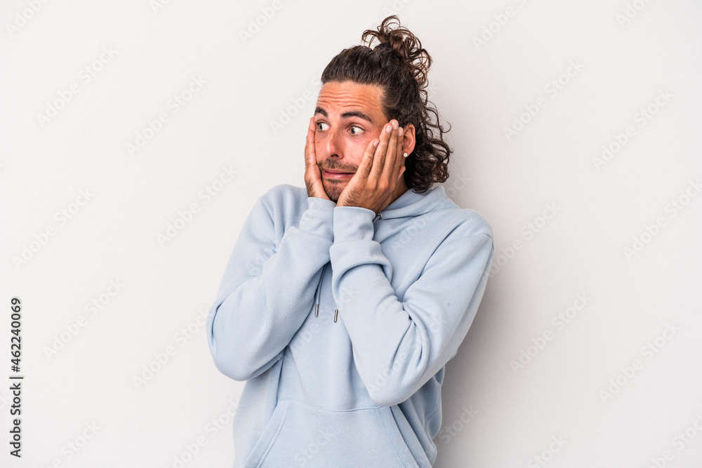 Young caucasian man isolated on gray background scared and afraid.